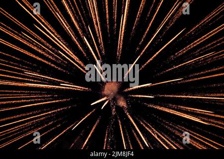 A vibrant red firework exploding in the night sky Stock Photo - Alamy