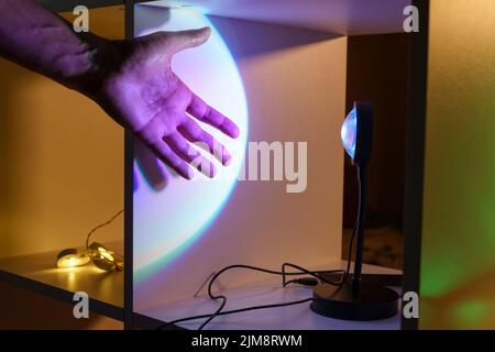 Sunset projector lamp. Multi colored RGB light. Home decor, interior. Selective focus Stock Photo