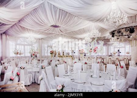 Before the wedding banquet. A large hall in the restaurant, prepared for a wedding dinner. Stock Photo
