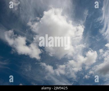 large white cotton ball clouds against a blue sy Stock Photo