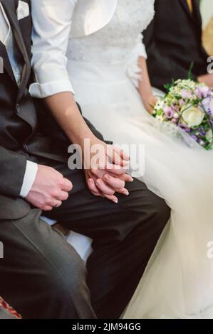 Bridal couple holding hands Stock Photo