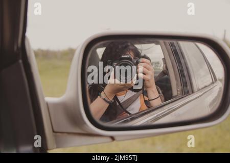 photographer in car mirror Stock Photo