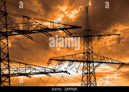 Many electric poles with clouds on sky Stock Photo