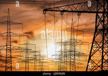 Many electric poles with clouds on sky Stock Photo