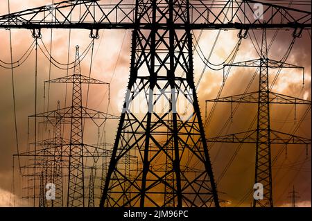 Many electric poles with clouds on sky Stock Photo