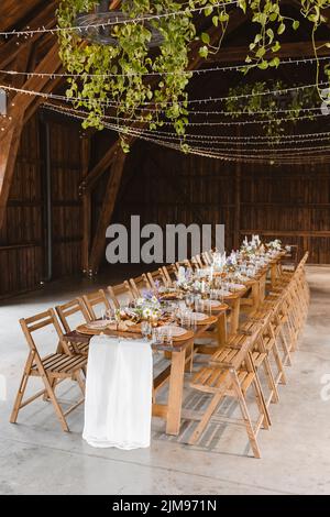 A beautifully set table for celebrating a party. Tableware sets for guests. Decor for a wedding celebration Stock Photo