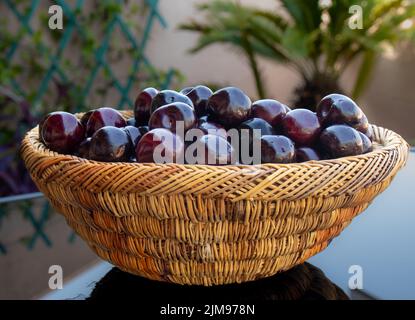 Close up of fresh ripe cherries , in a colorful wicker basket of fresh ripe cherries , in a colorful wicker basket Stock Photo