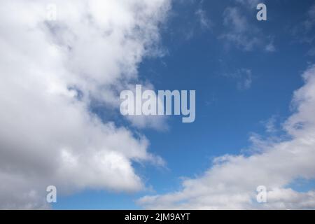 White clouds on a clear blue sky Stock Photo