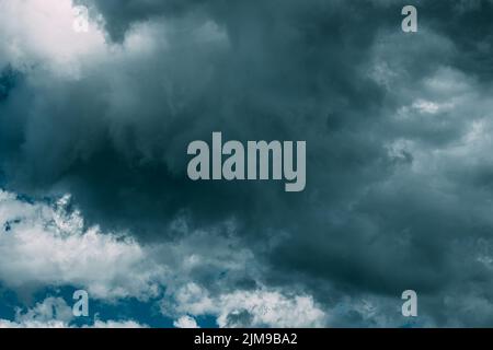 Dark Blue Cloudy Rainy Sky With Rain Heavy Clouds. Storm, Thunder, Thunderstorm, Storm clouds. Sky Natural Background. Cumulonimbus Cloud. Strange Stock Photo