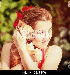 Cute Girl and Her Chihuahua Dog on Nature Background. Stock Photo