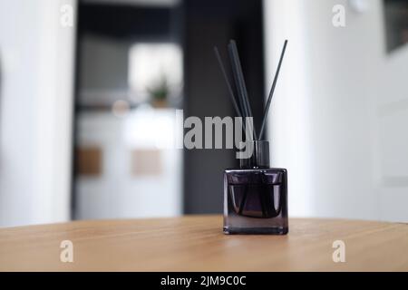 Reed freshener on table in light room, closeup Stock Photo