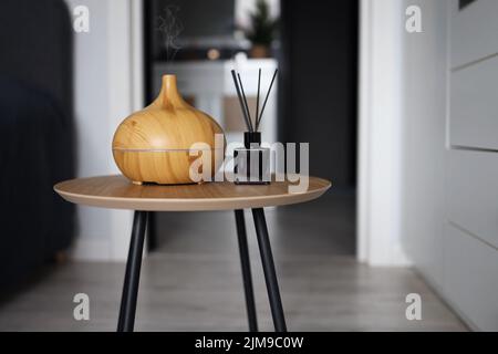 Aroma oil diffuser on table at home. Air freshener Stock Photo