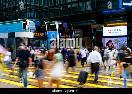 Hong Kong, China. 5th Aug, 2022. People wear face mask cross a street in financial district. (Credit Image: © Keith Tsuji/ZUMA Press Wire) Stock Photo