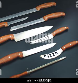 Modern Kitchen Knives Set on Grey Background. Chef s Knives Concept Stock Photo