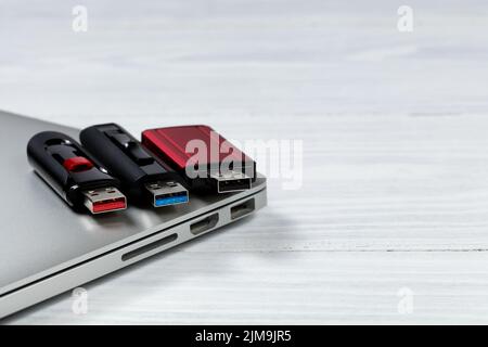 Thumb drives with different colors for USB speed technologies on top of computer Stock Photo