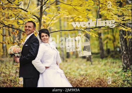 Happy wedding couple in autumn day with sign mrs  mr Stock Photo