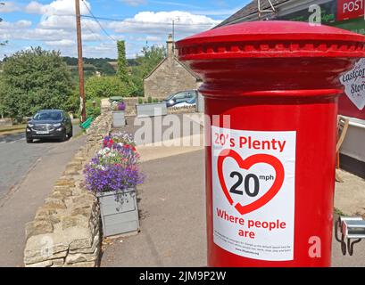 20s plenty, Where People Are, slow down, sign, on postbox, Eastcombe village, Stroud, Gloucestershire, England, UK, GL6 7EB Stock Photo