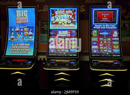 Fruit machines, one-armed bandits, cash video games, at Motorway Services M6, England, UK. Dangers of casual gambling Stock Photo