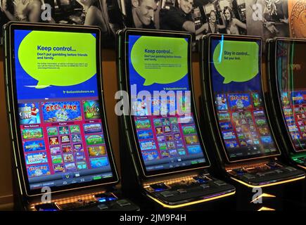 Fruit machines, one-armed bandits, cash video games, at Motorway Services M6, England, UK. Dangers of casual gambling Stock Photo