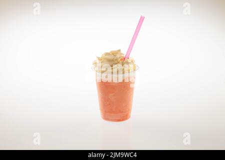 Strawberry gelato ice cream shake with whipped cream on top and straw. Stock Photo