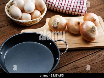 Still life with onions and quail eggs on a kitchen table Stock Photo