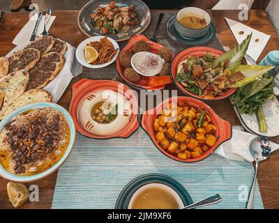 Fancy Lebanese Middle Eastern breakfast, Freshly baked Flatbread of cheese, appetizers - Arabian food manouche - Levantine cuisine Stock Photo