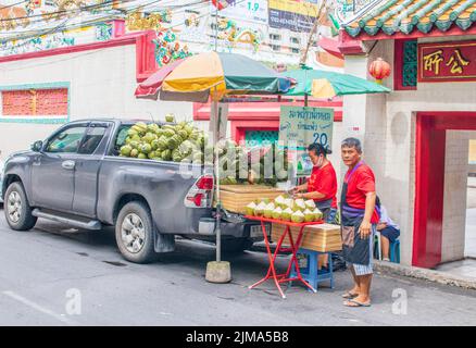 Street sale of young green coconuts as a refreshing drink in Bangkok Thailand Southeast Asia Stock Photo