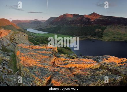 The lakes of Crummock Water and Buttermere seen from the summit of Rannerdale Knotts in the Lake District at sunset. Stock Photo