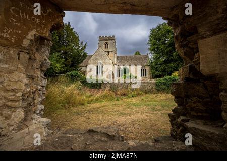 St Kenelm’s Church from the ruins of Minster Lovell Hall, Cotswolds, Oxfordshire, England Stock Photo