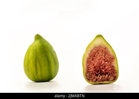 Ripe green figs and a sliced half on white background, clipping paths included Stock Photo