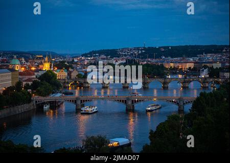 Famous bridges over river Vltava in the old town of Prague after sunset, during blue hour Stock Photo
