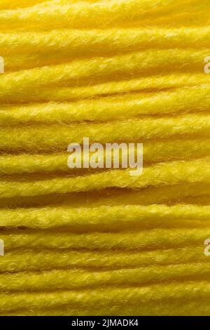 macro, abstract of bright yellow rug yarn strings, background texture, textile and needlework concept, soft-focus Stock Photo