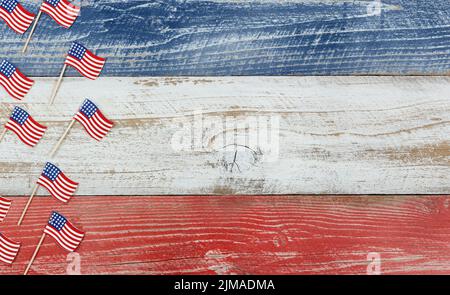 Mini USA flags on rustic wooden boards painted in national colors Stock Photo