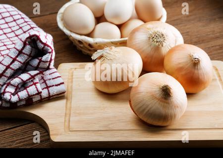 Still life with onions and quail eggs on a kitchen table Stock Photo