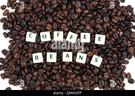 COFFEE BEANS white cube text on white background AND coffee beans background Stock Photo