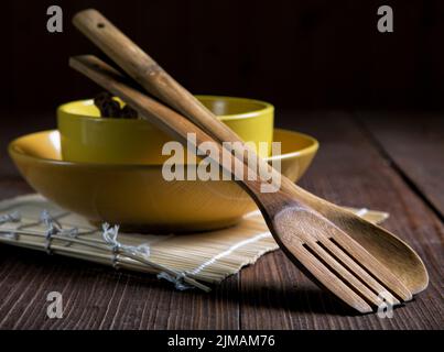 Still life with plates and spatulas for food on an old table Stock Photo