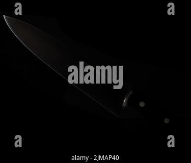 A closeup shot of Henckels brand kitchen knife on the black background Stock Photo