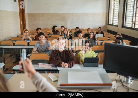 Diverse students listening to teacher Stock Photo
