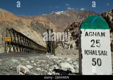 Agham, Leh, India 09 April 2022 - Signage With Distance To Agham Village And Khalsar Distance On Roadside Highway On The Way To Pangong Tso Lake In La Stock Photo