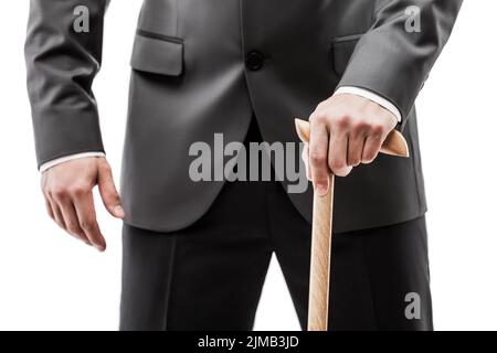 Businessman in black suit holding walking cane stick Stock Photo