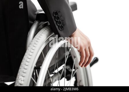 Invalid or disabled businessman in black suit sitting wheelchair Stock Photo