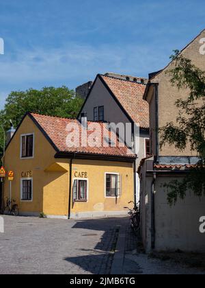 A vertical shot of cozy Cafe Gula Huset HB - Cafe in Visby, Sweden under blue sky Stock Photo