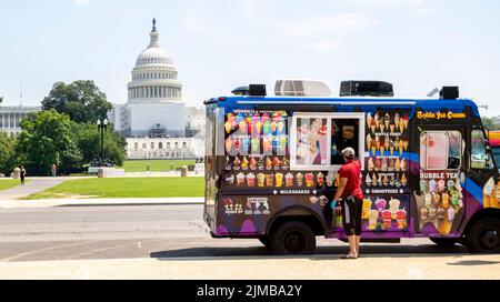 August 4, 2022, Washington, District of Columbia, USA: Ice cream trucks drivers check on one another during a heat wave in Washington, DC on Thursday. The National Weather Service issued a heat advisory, after temperatures were forecasted to reach 95°F, with a heat index of 105° F. (Credit Image: © Dominic Gwinn/ZUMA Press Wire) Stock Photo