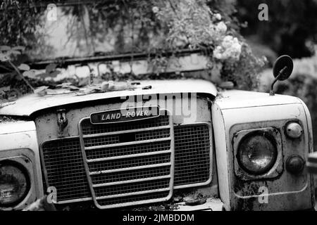 Manchester UK 25 July 2022 black and white image of front of old Land rover 4 x 4 off road vehicle showing grill logo and headlights Stock Photo