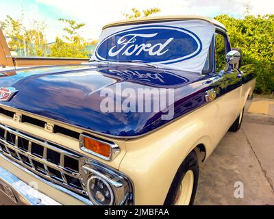 Ford blue oval logo and brand on the windshield of an old F100 V8 utility pickup truck 1963. Expo Fierros 2022 classic car show Stock Photo