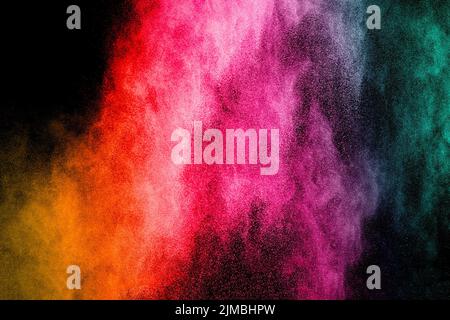 Multicolored powder explosion on black background..  Freeze motion of color dust  particles splash. Stock Photo