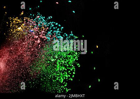 Multicolored powder explosion on white background. Colored cloud. Colorful dust explode. Paint Holi. Stock Photo