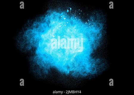 Bizarre forms of  blue powder explode cloud on background. Launched blue dust particles splashing. Stock Photo