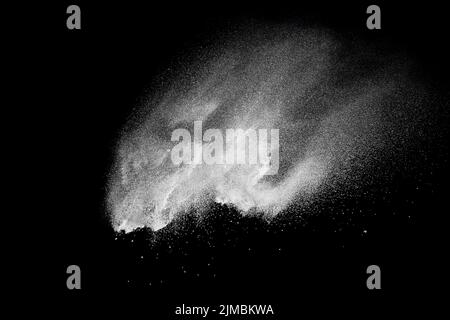 Bizarre forms of white powder explosion cloud against black background.White dust splash. Stock Photo