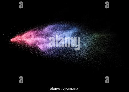 Multi color particles explosion on black background. Stock Photo